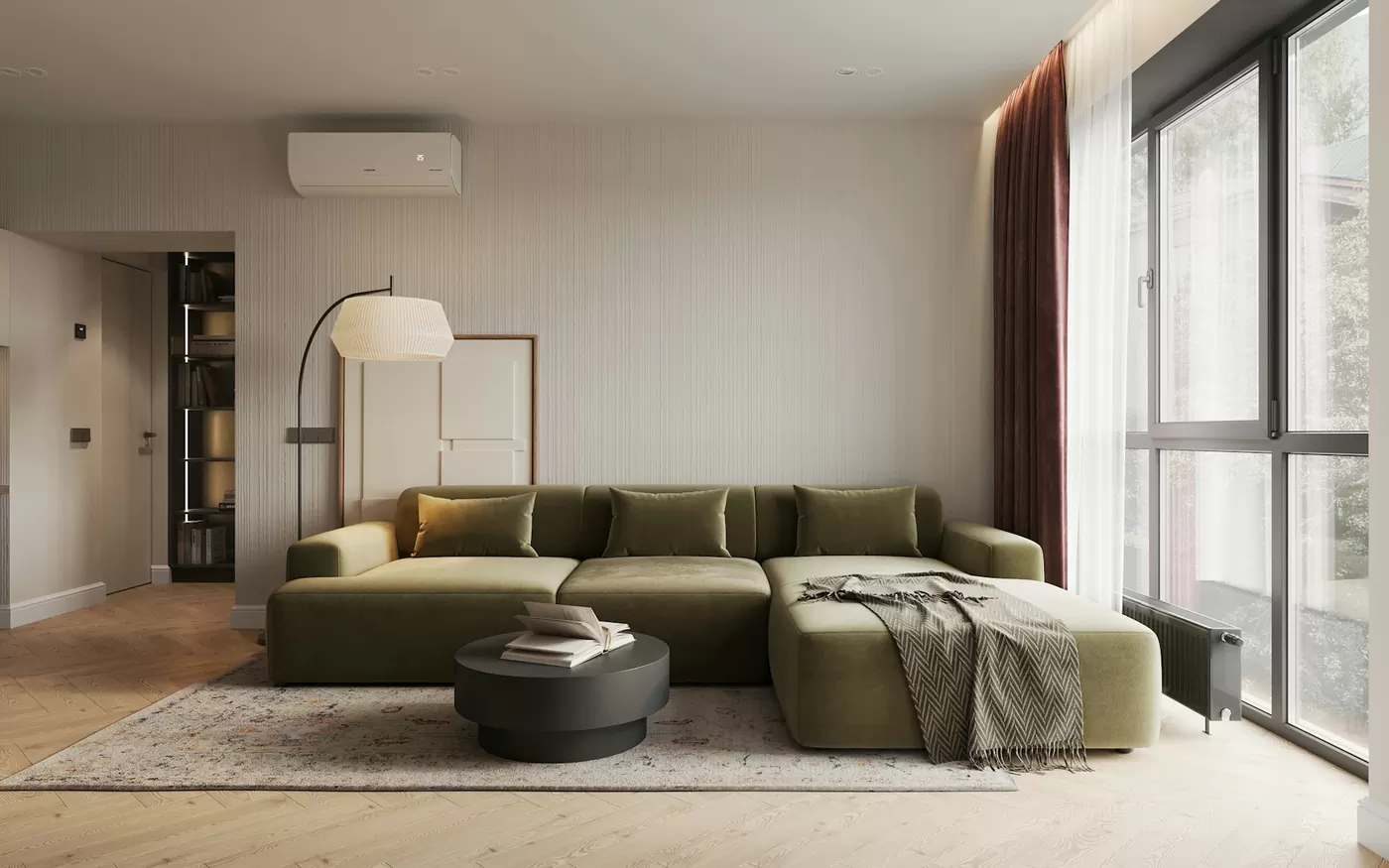 Salon lumineux d'un appartement géré par Simply Home, canapé vert et grande baie vitrée